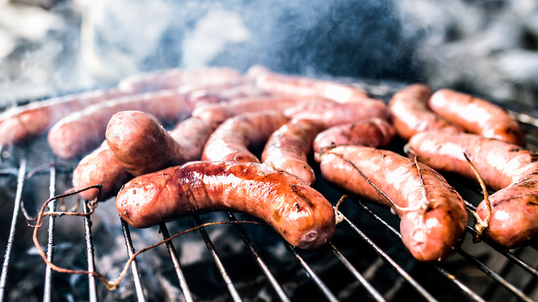 sausages cooking on grill 