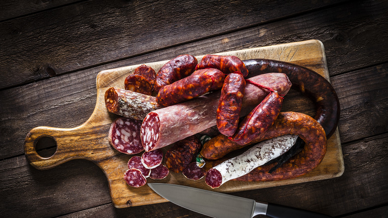 assortment of sausages on cutting board 