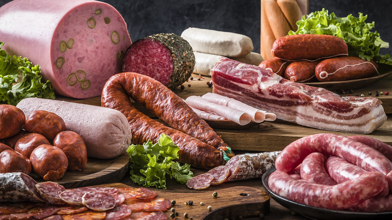 various types of meats assorted on cutting boards