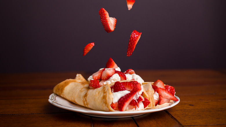 strawberries with cream on pancakes