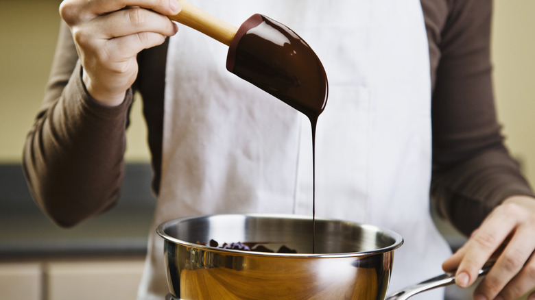 Melted chocolate dripping off spatula