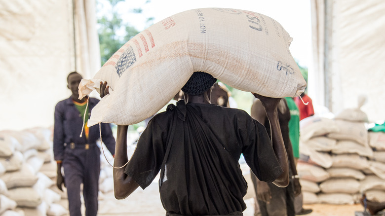 man carrying food aid