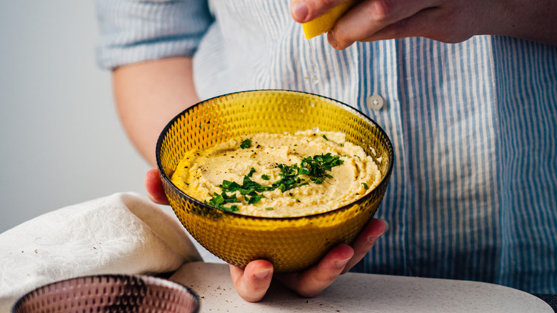 home cook preparing fresh hummus 