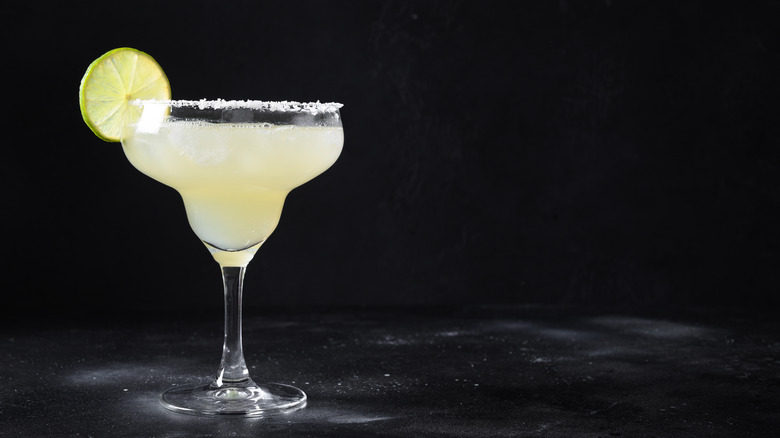 Classic daiquiri in a margarita glass with salt rim and lime wedge