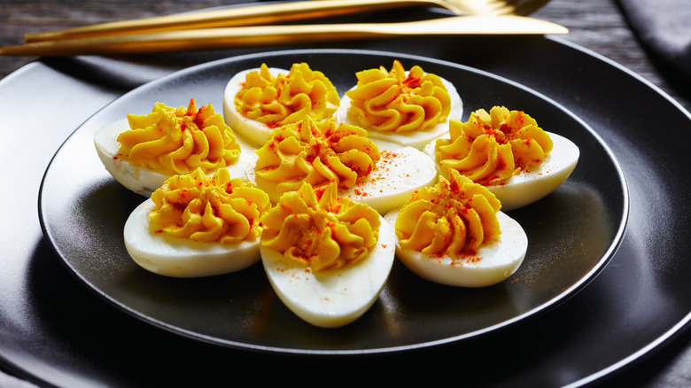 Deviled eggs and gold utensils