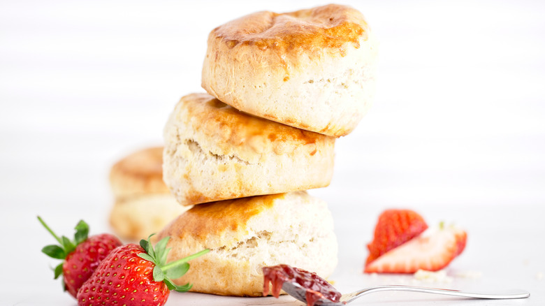 stack of biscuits with spoonful of strawberry jam