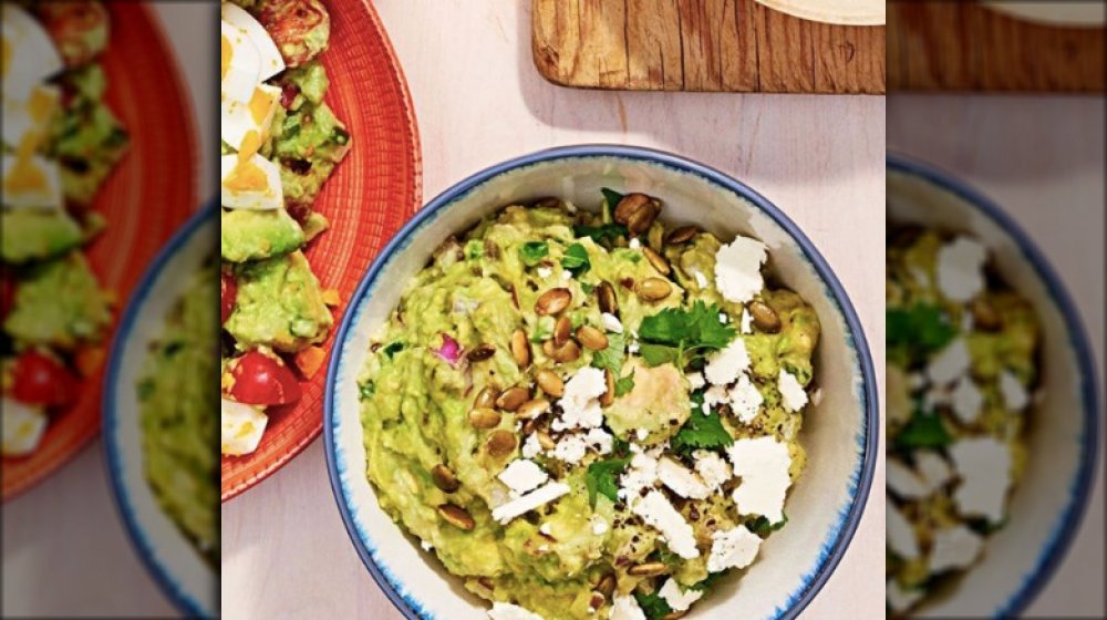 guacamole topped with pepitas and cotija cheese