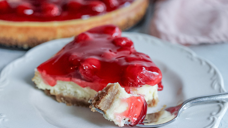 Bite of cherry cheesecake on fork