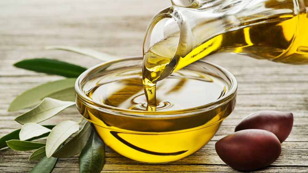 Olive oil getting poured into a small bowl