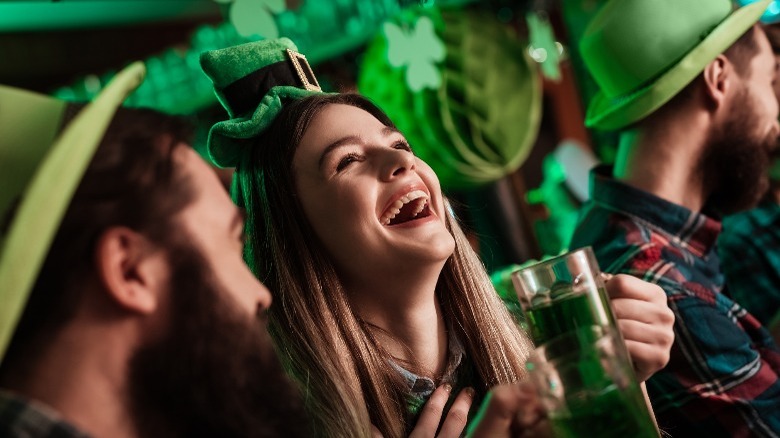 People celebrating St. Patrick's Day with green beer