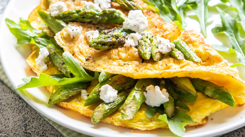 Asparagus omelette on white plate