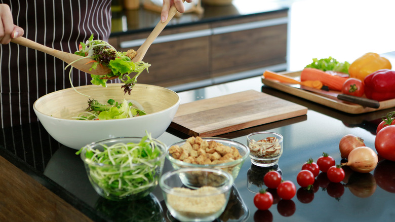 salad ingredients arranged around bowl