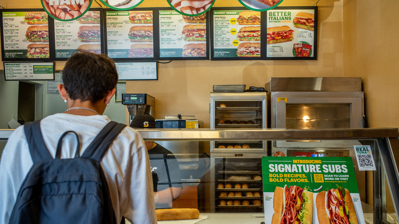 Customer waiting at Subway counter