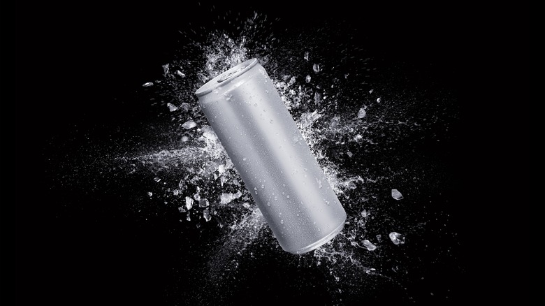 Silver can with explosion of drink