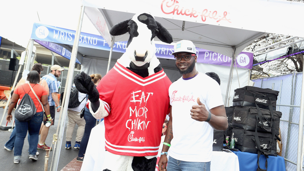 Chick-fil-A cow and man in Chick-fil-A t-shirt