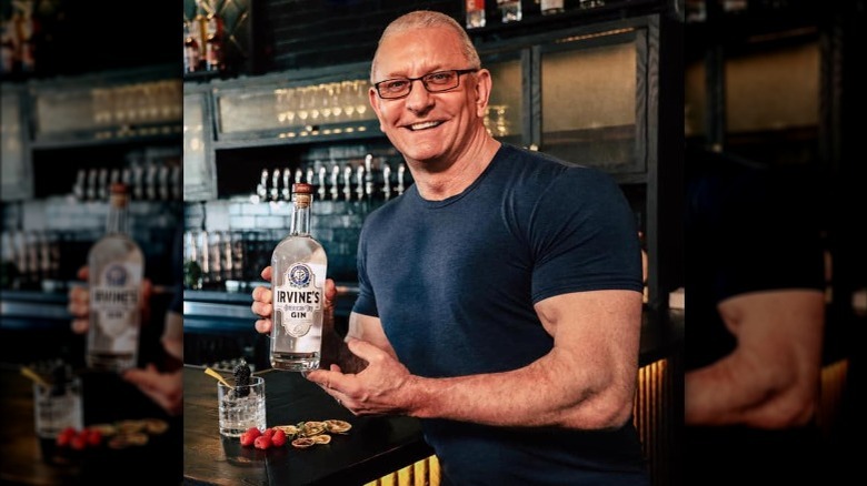 Robert Irvine holds bottle of gin