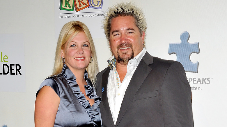 Lori Fieri and Guy Fieri smile beside each other