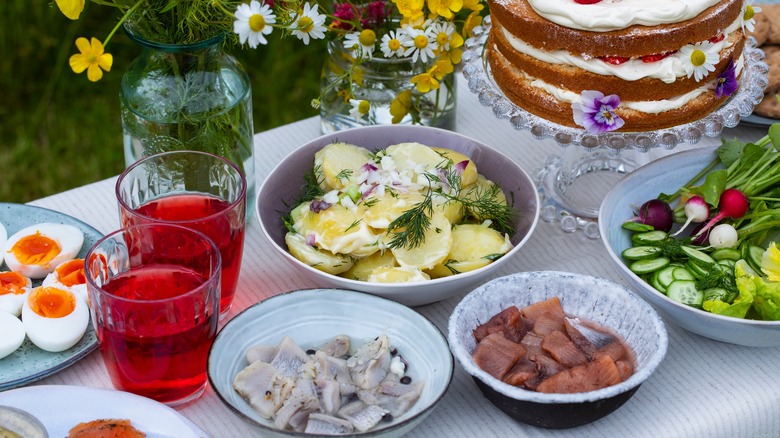 Table set with pickled herring and potatoes