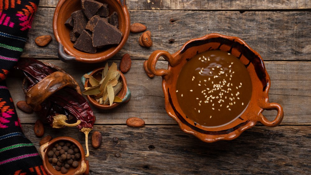 Mole sauce in a bowl surrounded by ingredients