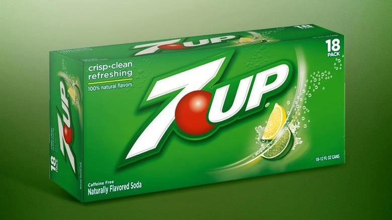 A box of 7UP with the logo prominently displayed against a gradient green background