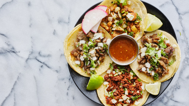 Black plate of tacos