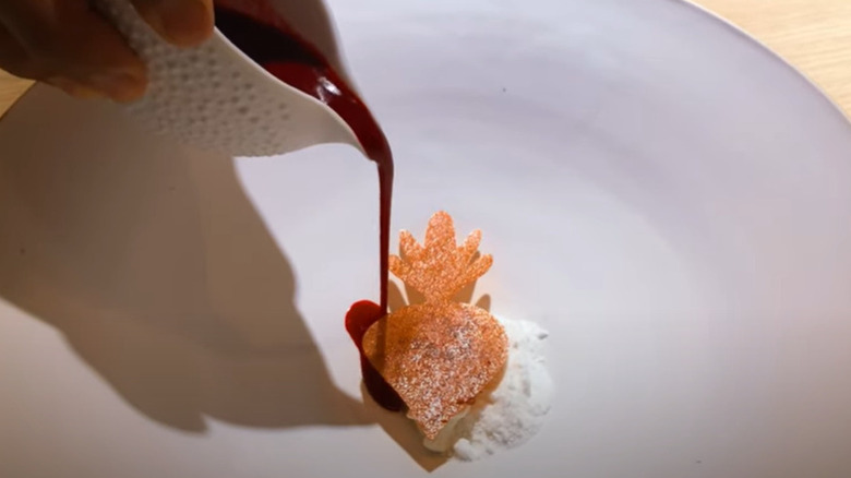 Pouring chocolate on a white plate