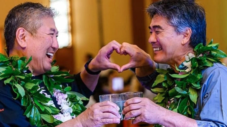 Wong and man making heart with hands