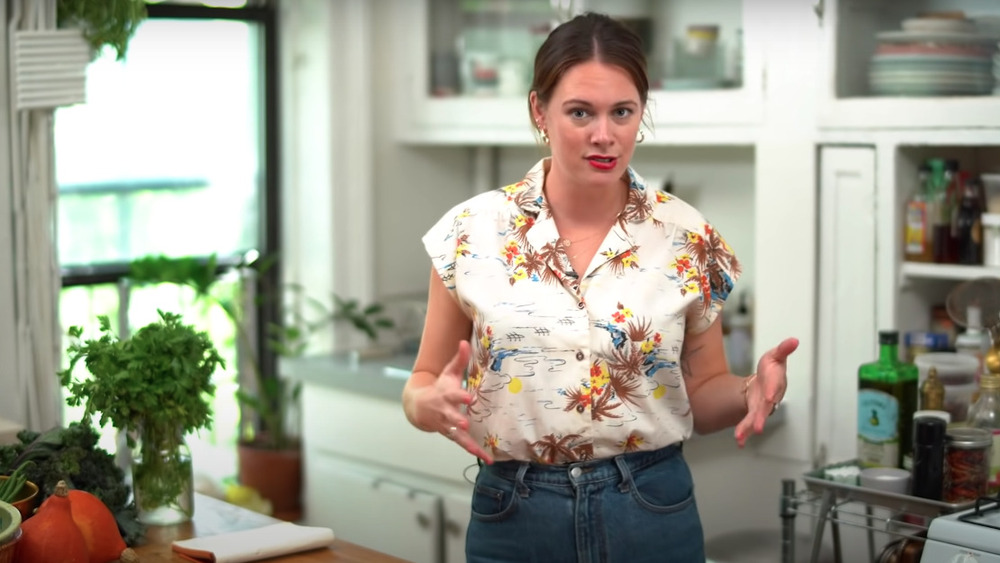 Alison Roman standing in kitchen