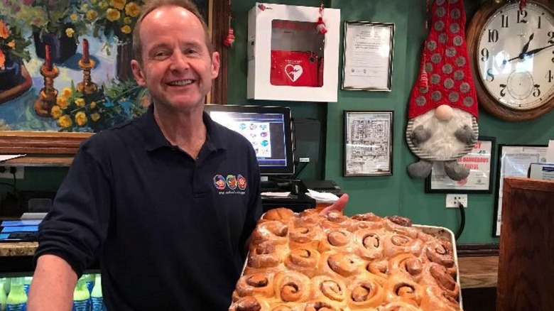 Tom Tunney with a tray of cinnamon rolls