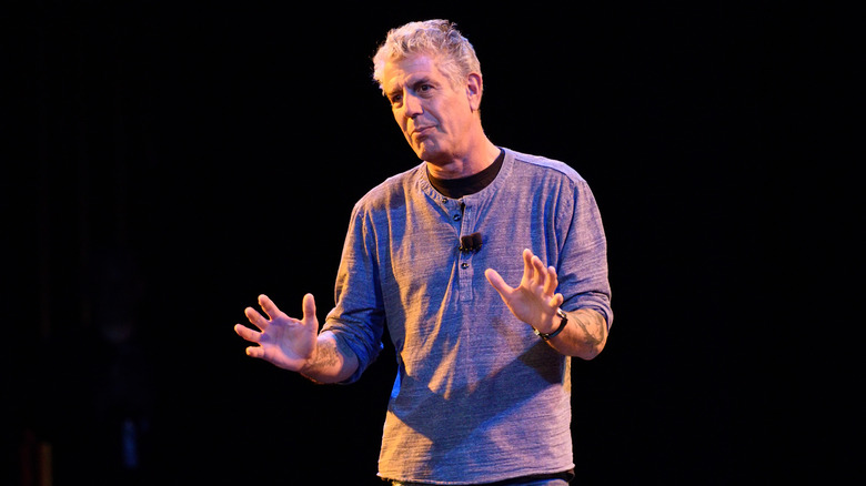 Anthony Bourdain with hands up