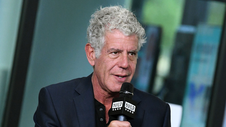 Anthony Bourdain holding microphone