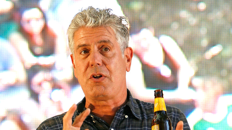 Anthony Bourdain holding a beer