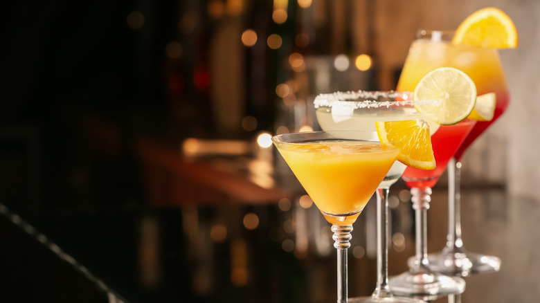 Cocktails with citrus on brown wooden table