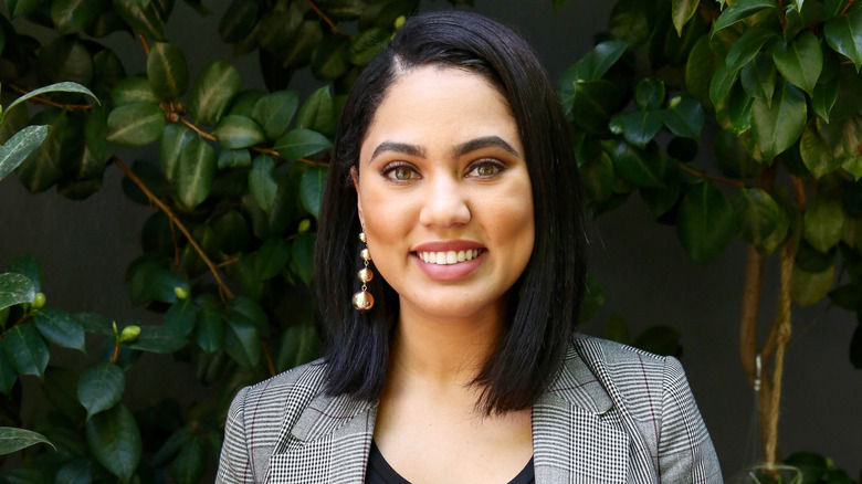 Ayesha Curry in front of greenery