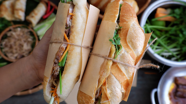 Two wrapped banh mi sandwiches