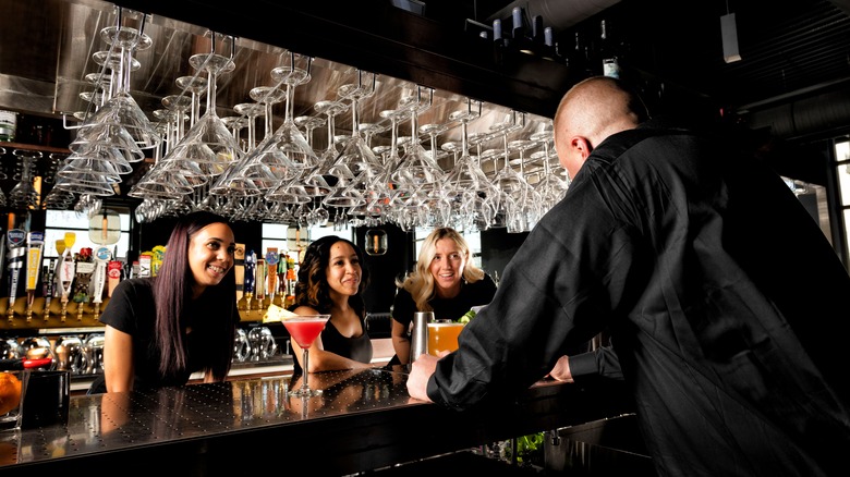 women sitting at a bar