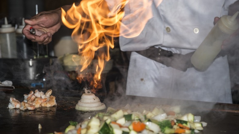 teppanyaki chef lighting onion volcano