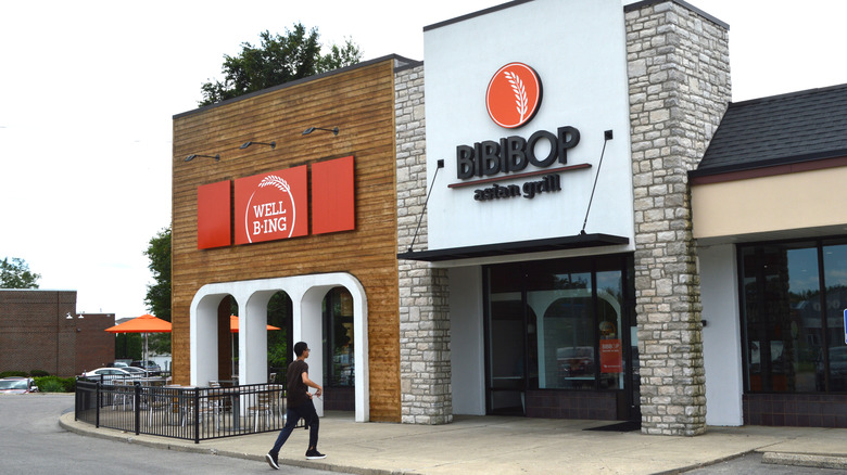 A person walking toward a Bibibop restaurant