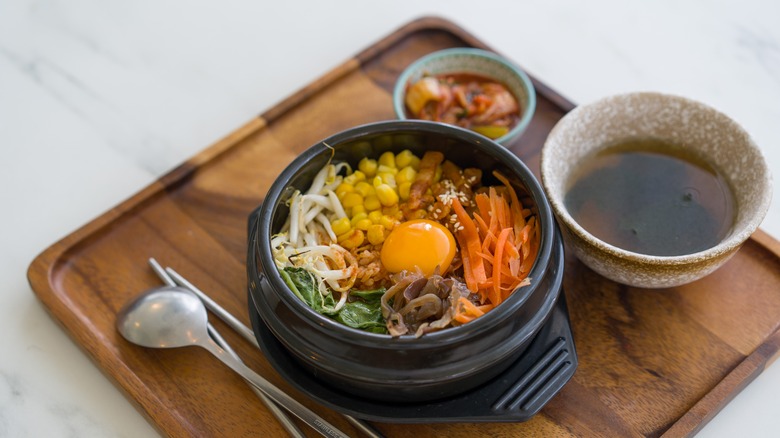 Bibimbap and soup on wood tray