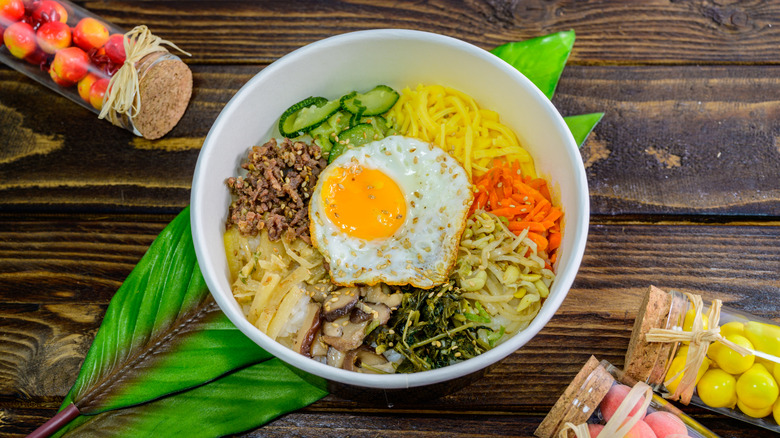 Bibimbap with fried egg on wood table