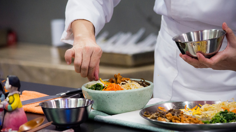 Bibimbap being prepared in kitchen