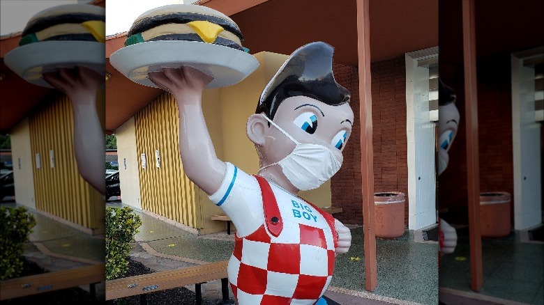 big boy statue wearing mask