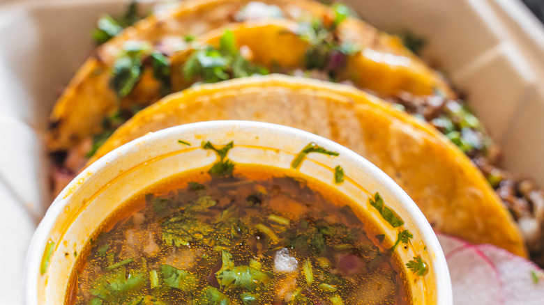 birria tacos and consomé cup