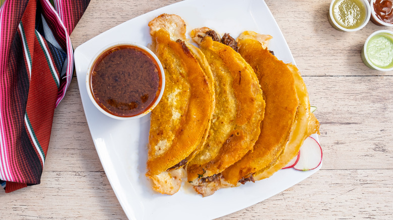 cheesy birria tacos with consomme 