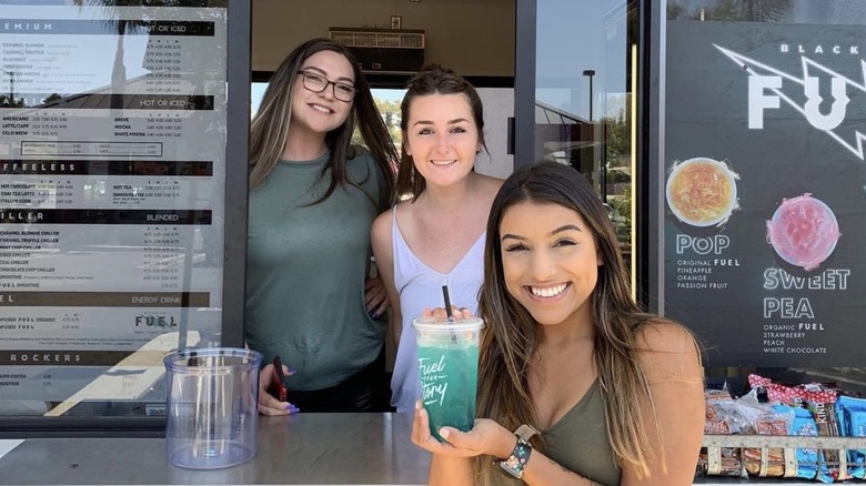 Employees in the window of a Black Rock Coffee Bar