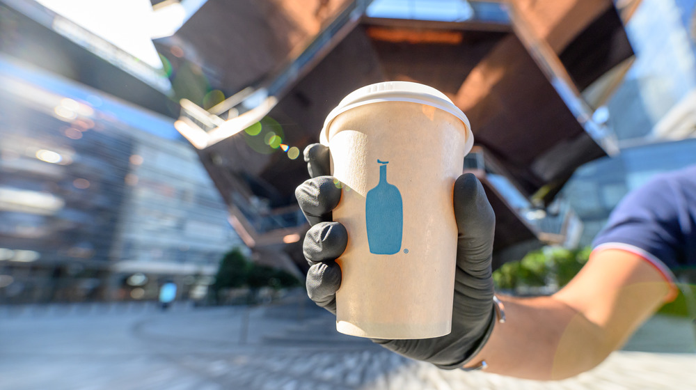 A to-go cup of Blue Bottle coffee