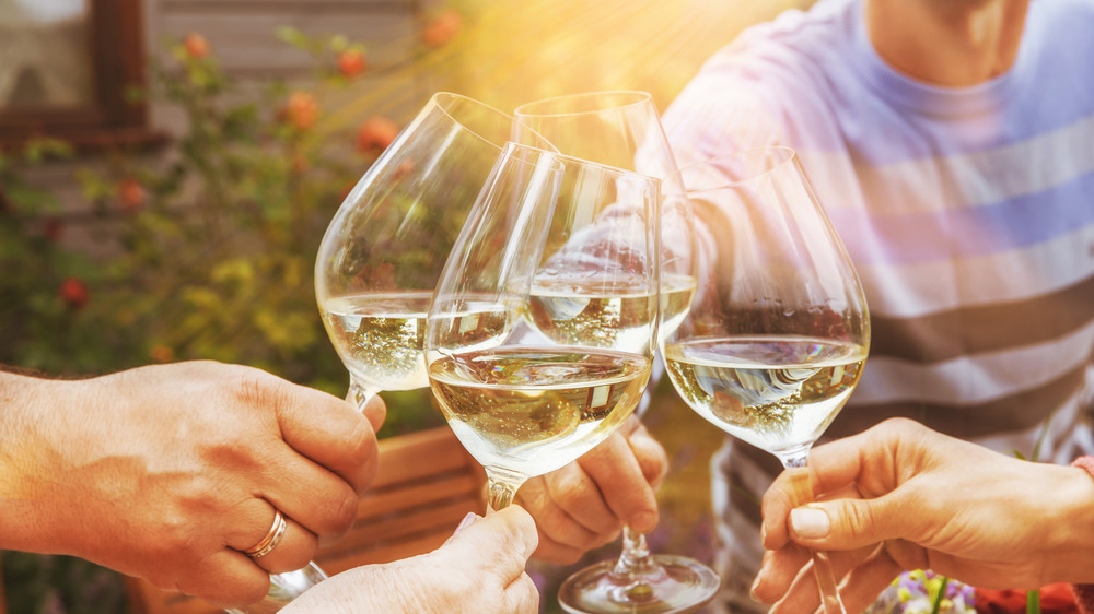 People enjoying white wine outdoors