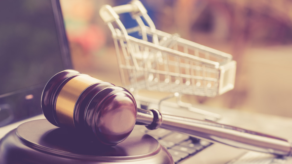 Judge's gavel with grocery cart in background