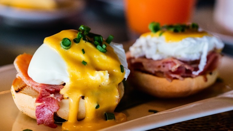 Eggs benedict on white plate