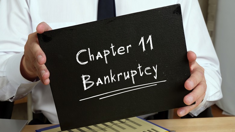 Man holds bankruptcy sign